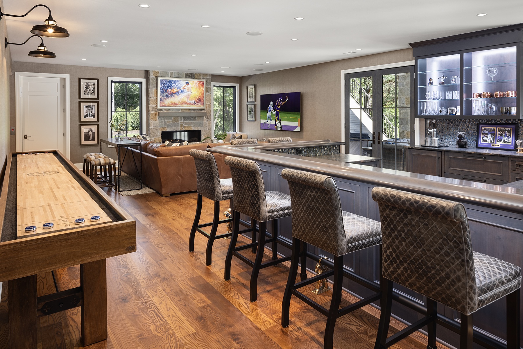 Minnesota home pub with custom leather bar stools and tailored seating by Traditions