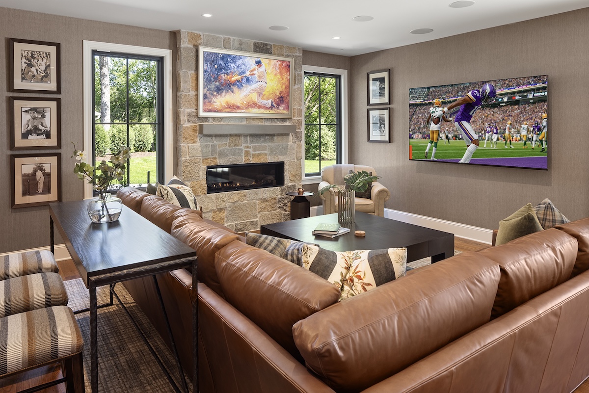 Lower-level family room in Wayzata, Minnesota with leather sectional illustrating Wayzata Minnesota interior design