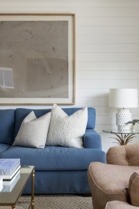 A cozy blue sofa mixed with traditional chairs and coffee table.