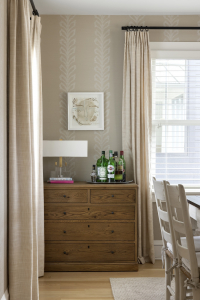 Elegant bar cabinet, styled with glassware and decorative accents