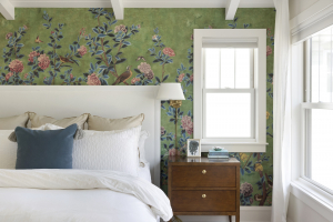 Primary bedroom in a South Minneapolis home featuring green patterned wallpaper, soft furnishings, and a cozy atmosphere
