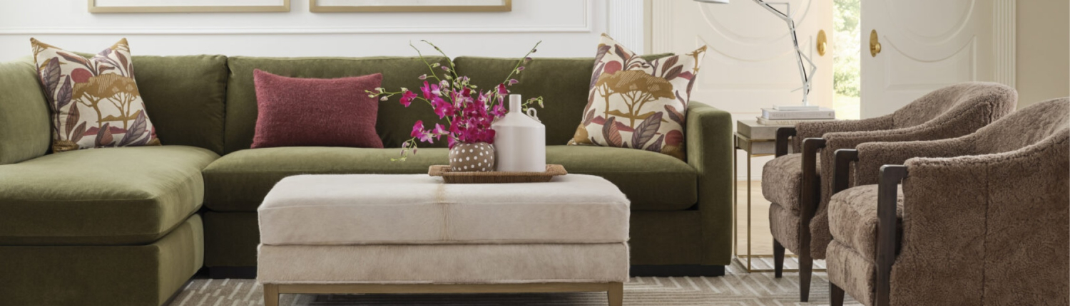 Living room featuring a green sectional with layered neutrals and warm textures by Traditions in Minneapolis and Naples
