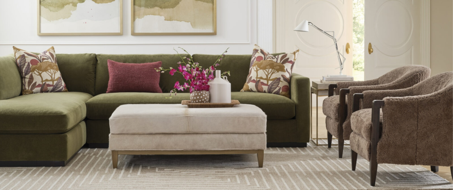 Living room featuring a green sectional with layered neutrals and warm textures by Traditions in Minneapolis and Naples