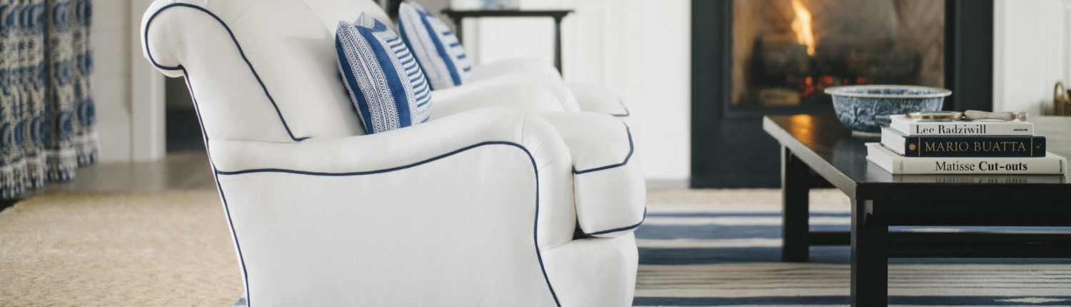 Minnesota family room with blue and white chairs, a cozy fireplace, and layered textures by Traditions