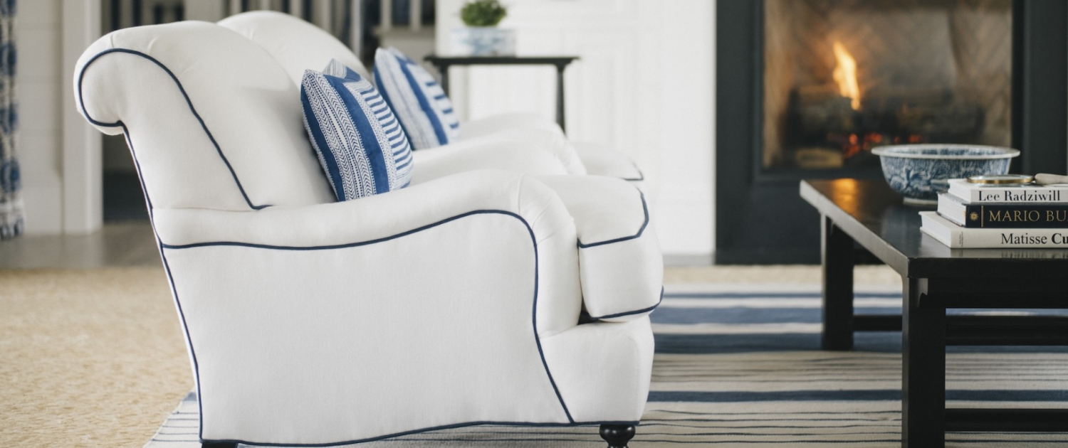 Minnesota family room with blue and white chairs, a cozy fireplace, and layered textures by Traditions