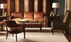 Traditional Minnesota living room with a rich leather sofa and a plaid ottoman.
