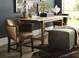 Leather and wood arm chair with a skirted plaid ottoman at a desk, find items alike at Traditions through the interior designer trade program.