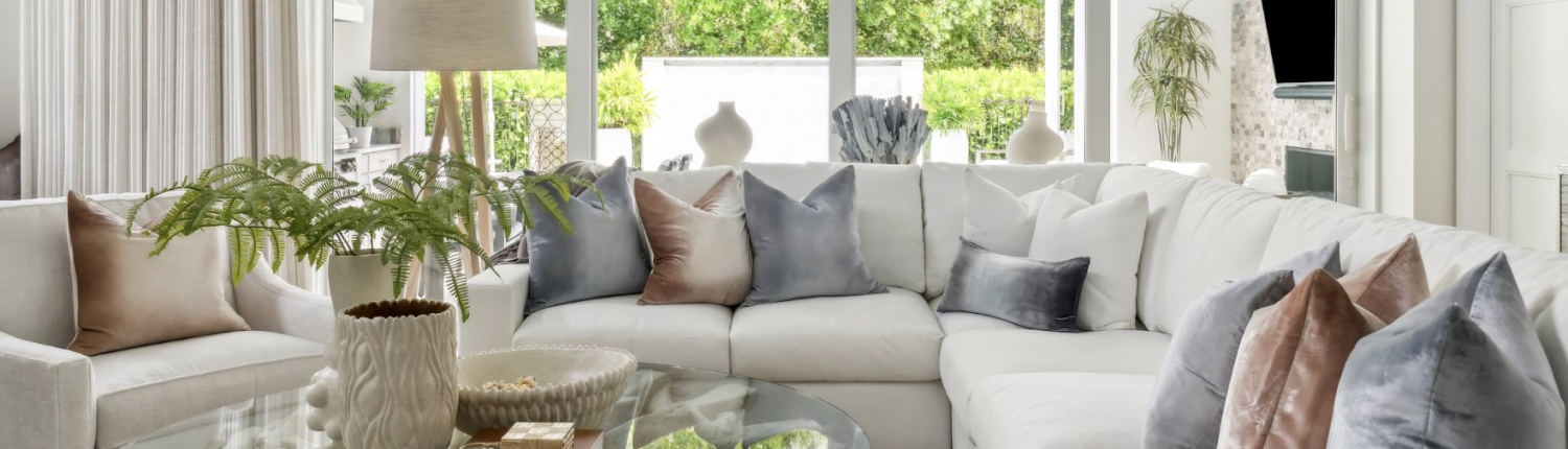 Contemporary Naples living room with a white sectional, neutral tones, and a bright, open feel.
