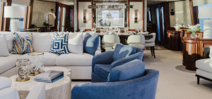 Furnished yacht living room in Naples, Florida with blue and white nautical-inspired sofas and décor.