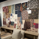 Showroom display at High Point Market Spring 2026 featuring warm brown tones, carved wood furniture, and mixed fabric upholstery